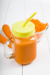 Carrot juice on a wooden table