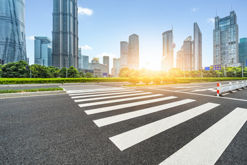 empty road with zebra crossing and skyscrapers in shanghai