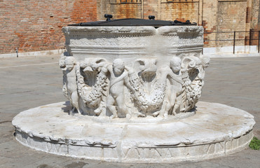 ancient stone well in a square of a European city