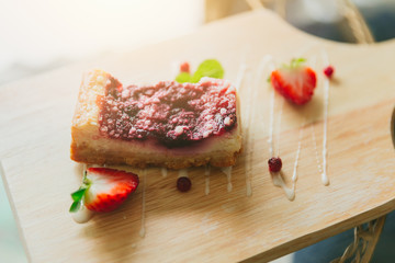 strawberry cheesecake on wood in the cafe delicious tasty fruity cake