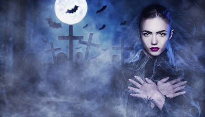 Fantasy Halloween Vampire woman portrait. Beauty Sexy Vampire in a cemetery, at night wearing...