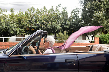 old woman driving a convertible car - obrazy, fototapety, plakaty