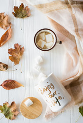 Fall still life with yellow leaves, coffe with marshmallows and 