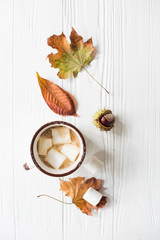 Fall still life with yellow leaves, coffe with marshmallows