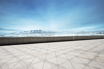 Obraz premium empty floor with beautiful snow mountains in blue sky