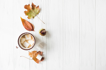Fall still life with yellow leaves, coffe with marshmallows