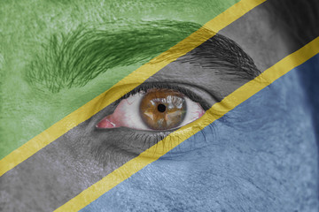 Human face and eye painted with flag of Tanzania