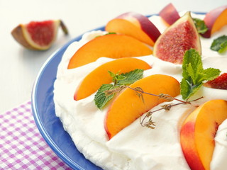 Traditional Pavlova dessert decorated with fruits. Selective focus.