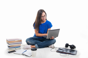 Fototapeta na wymiar Student girl sitting holding laptop with books around