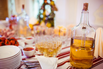 Bottle with honey vodka stands on the table