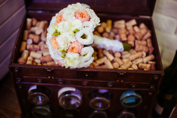 Wedding bouquet made of peonies lies on corks