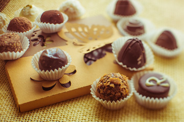 Delicious chocolates stand on paper box with batterflies