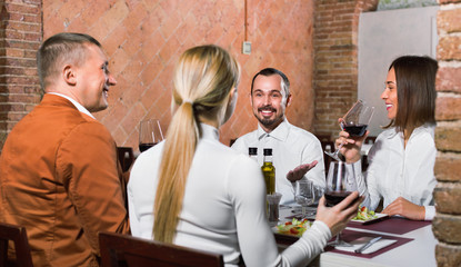 Group of people dining out merrily in country restaurant