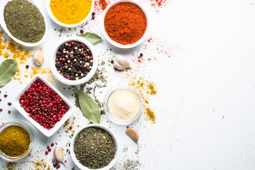 Set of spices in a bowls on white background. Top view.