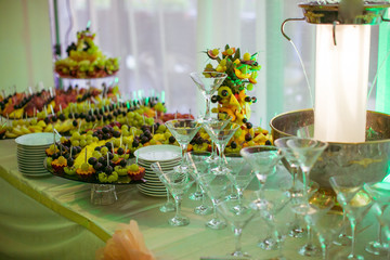 Cocktail glasses stand before shiny fountain