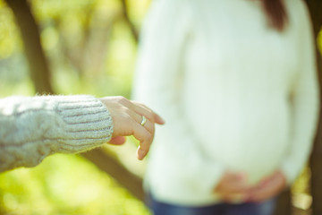 Man reaches out his hand in warm sweater
