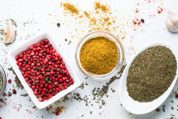 Various spices in a bowls on stone table.