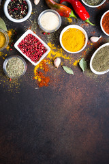 Various spices in a bowls on stone table. Top view with copy space.