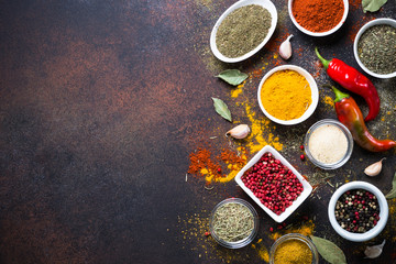 Various spices in a bowls on stone table. Top view with copy space.