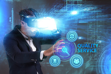 Business, Technology, Internet and network concept. Young businessman working in virtual reality glasses sees the inscription: Quality service