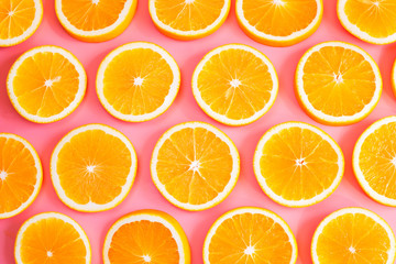 Fresh cut oranges on pink background. Top view.