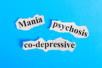 Mania co-depressive psychosis text on paper. Word Mania co-depressive psychosis on a piece of paper. Concept Image. Mania co-depressive psychosis Syndrome