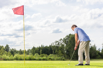 Senior man playing golf.