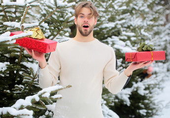 Surprised macho with presents on winter day