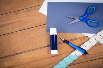 Directly above shot of scissor on papers with school supplies