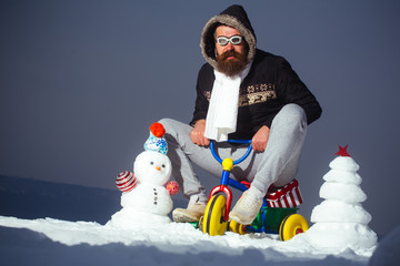 Snowman and snow xmas tree on winter landscape