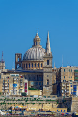 Fototapeta na wymiar Sicht auf die Kuppel der Karmelitenkirche in Valletta, Malta. Im Vordergrund ist St. Paul's. Aufgenommen von Sliema. 