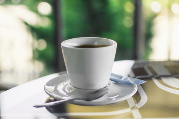 cup of coffee on a table in a cafe on a blurry background