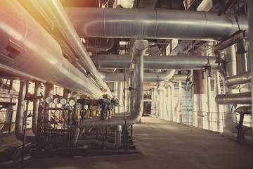 Equipment, cables and piping as found inside of a modern industrial power plant