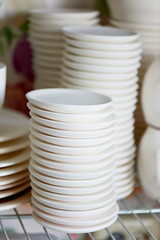 Set of white dishes isolated on white. Stack of plates