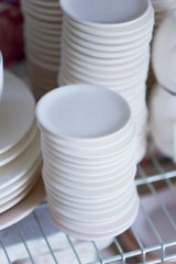 Set of white dishes isolated on white. Stack of plates