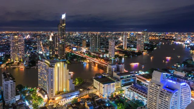 Aerial Bangkok Night Cityscape Riverside Chao Phraya River Of Thailand 4K Time Lapse (zoom in)