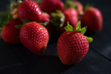 Strawberries on the dark wooden surface