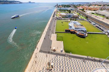 Panorama of Belem Tower or Torre de Belem and Tagus Estuary or Tejo river from Discoveries Monument or Padrao dos Descobrimentos platform. Aerial view of Belem District in Lisbon, Portugal, Europe.