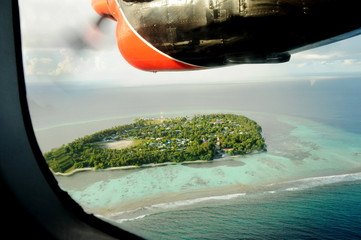 View through sea plane propeller over a maldivian island