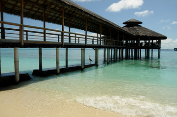 Wooden Pier off of Maldivian island looking out over the beautiful Indian ocean