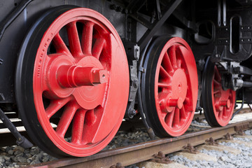 Fototapeta na wymiar Nice contrast locomotive red wheels detail