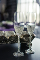 wedding glasses on a festive table with fruits and sandwiches with red fish, on a blurry background in the hotel room