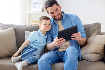 father and son with tablet pc playing at home