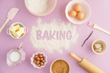 Flatlay collection of tools and ingredients for home baking on pink background with the word baking...