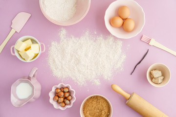 Flatlay collection of tools and ingredients for home baking with Flour copyspace in the center on...