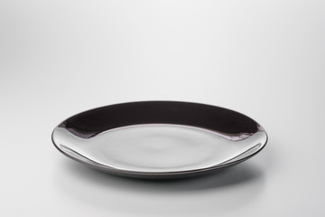 Black empty plate. Isolated on white background