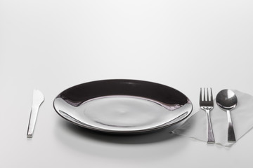 Black empty plate. Isolated on white background