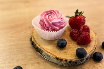 zephyr or marshmallow with berries on stand