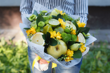 Green and yellow edible fruits and flowers bouquet 