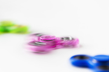 Obraz na płótnie Canvas close up of spinning fidget spinners